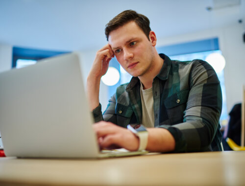 Jeune homme concentré sur son ordinateur