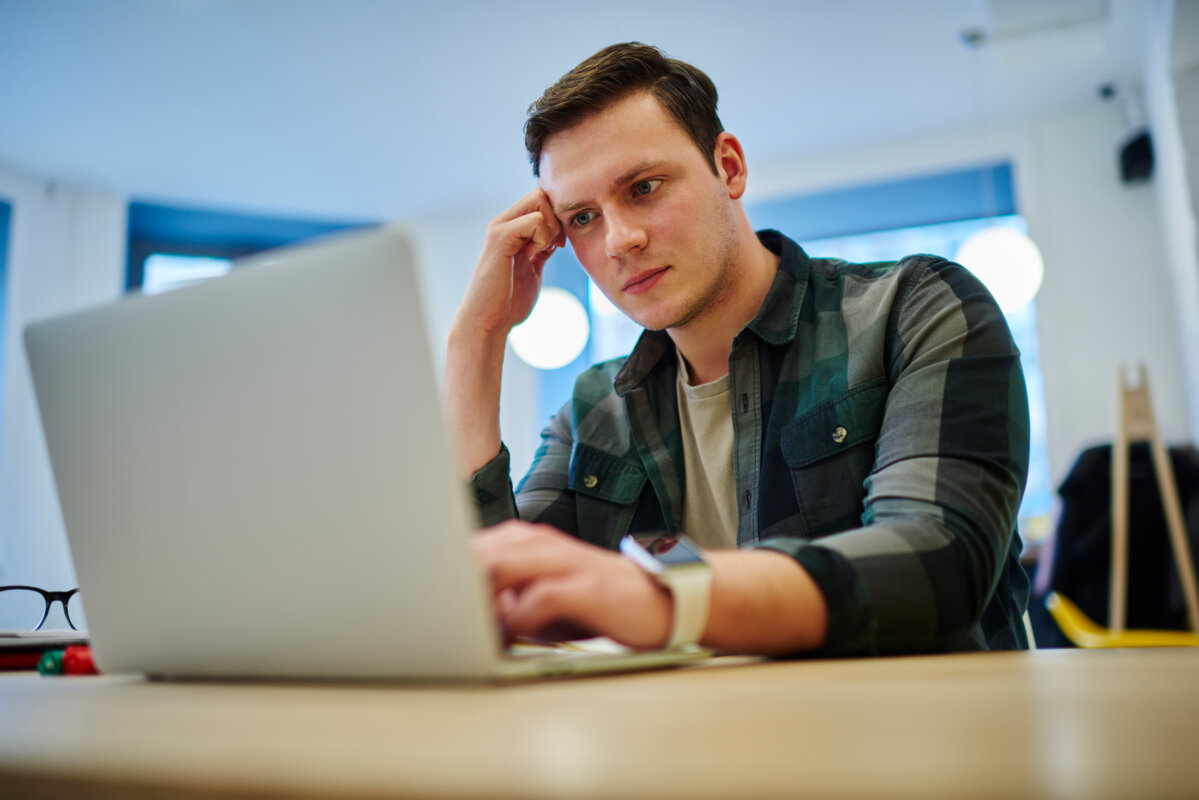 Jeune homme concentré sur son ordinateur